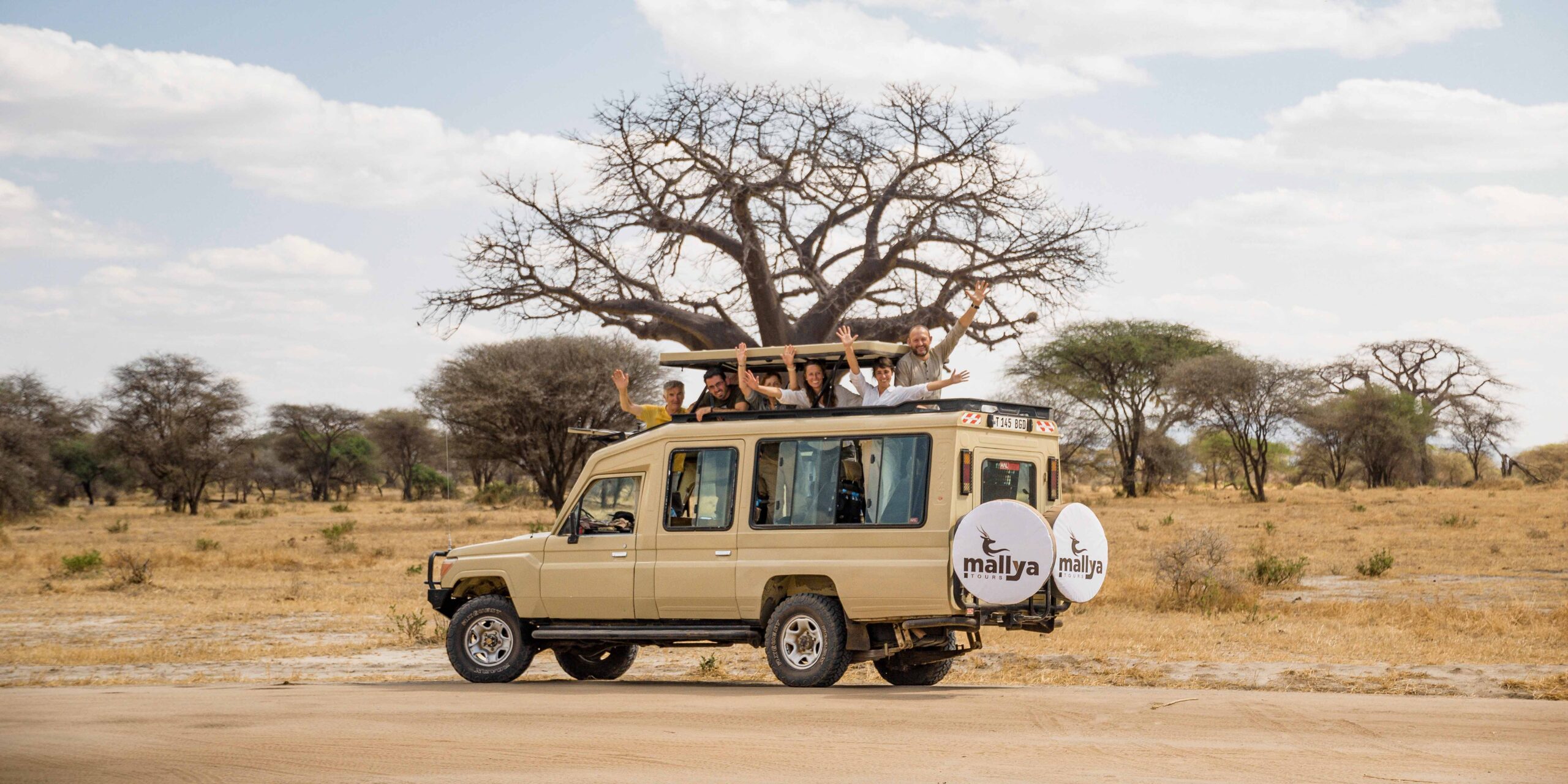 Happy Tourist on a Cruiser in Tarangire National Park-Mallya Tours