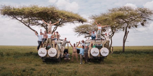 Group of Tourists in a 4x4 Safari jeep taking a picture at Serengeti National Park-Mallya Tours